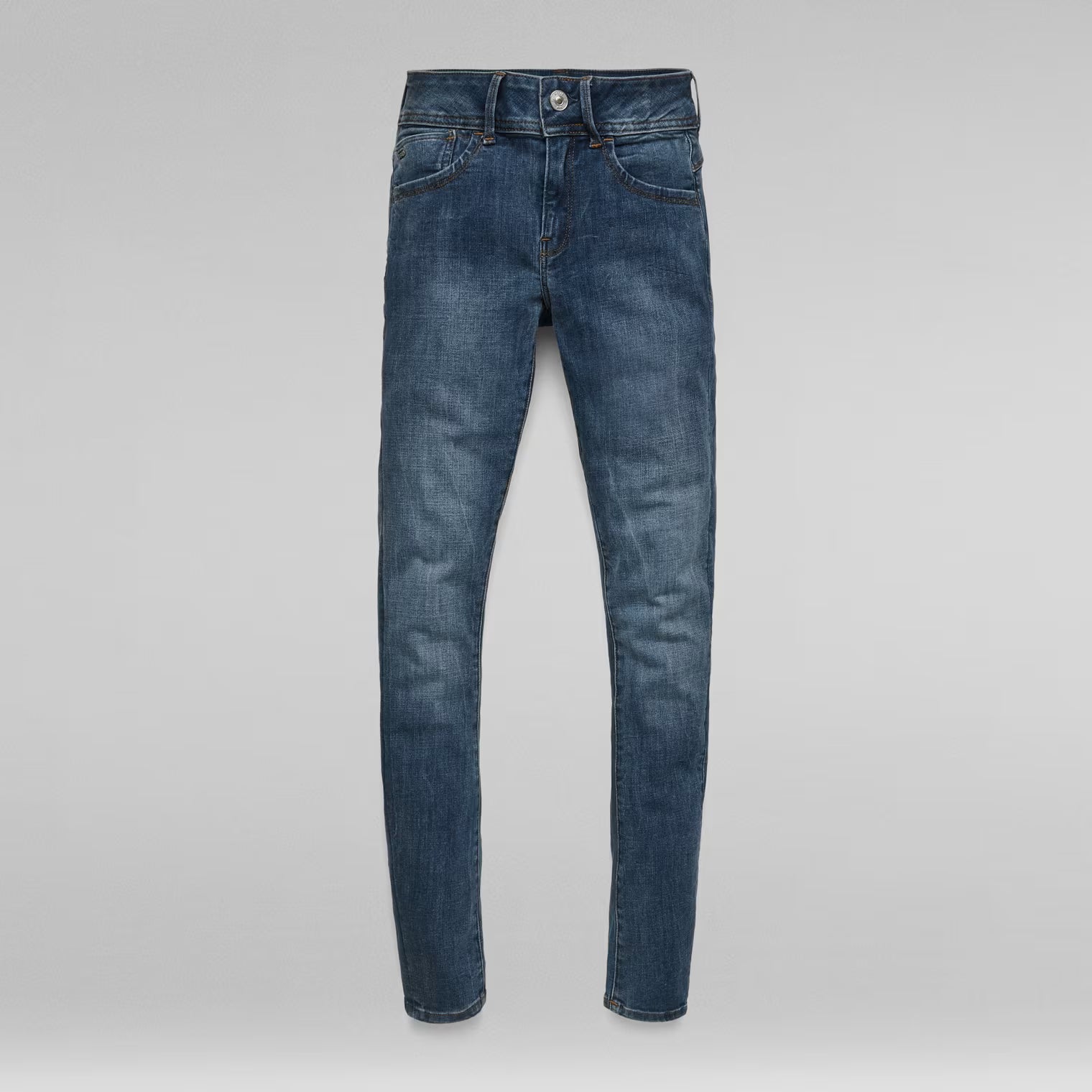 Packaging view of dark blue skinny jeans with the front visible and label shown.