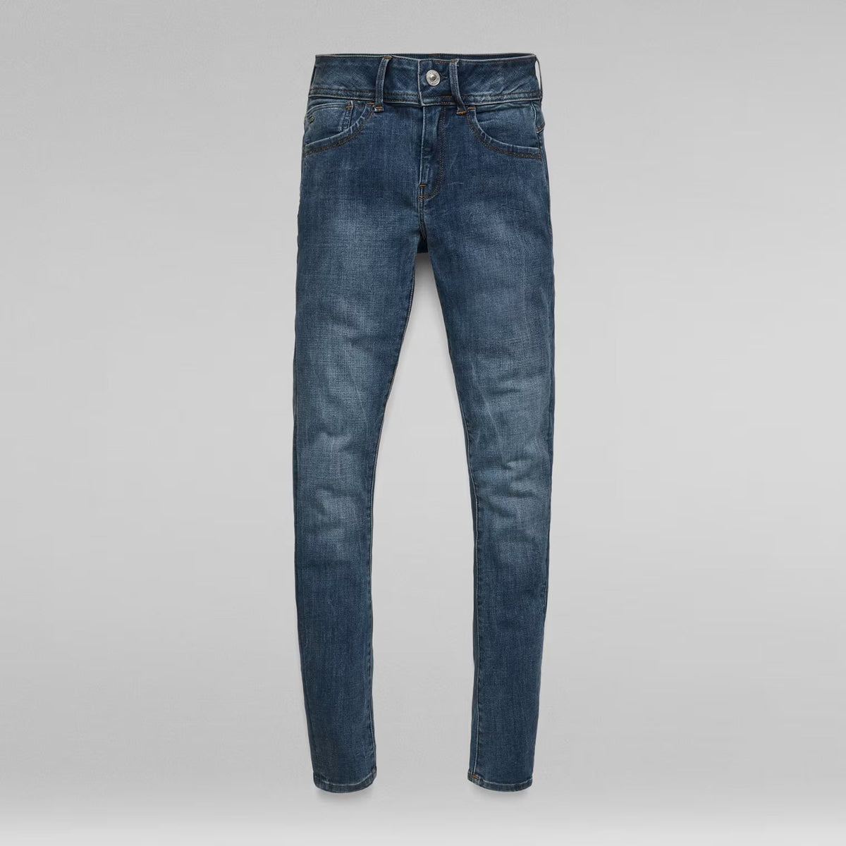 Packaging view of dark blue skinny jeans with the front visible and label shown.