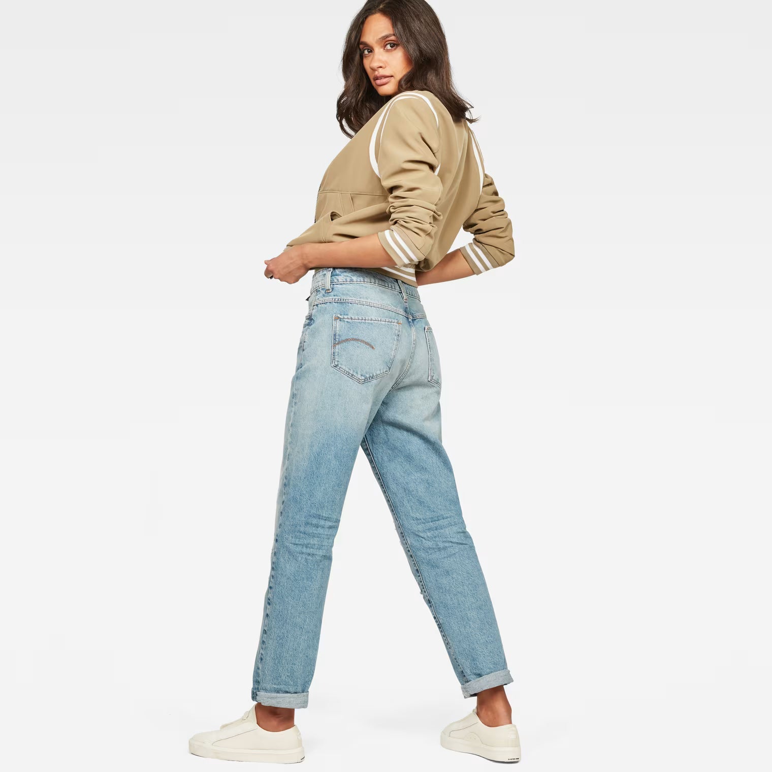 Back view of light blue high waist boyfriend jeans featuring a relaxed fit on a white background.