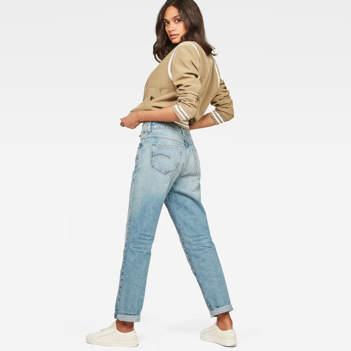 Back view of light blue high waist boyfriend jeans featuring a relaxed fit on a white background.