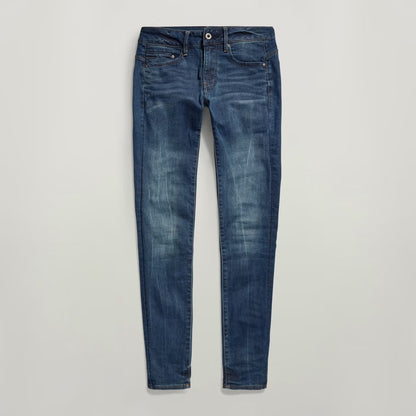 Close-up of dark blue skinny jeans with zipper detail on a white background.