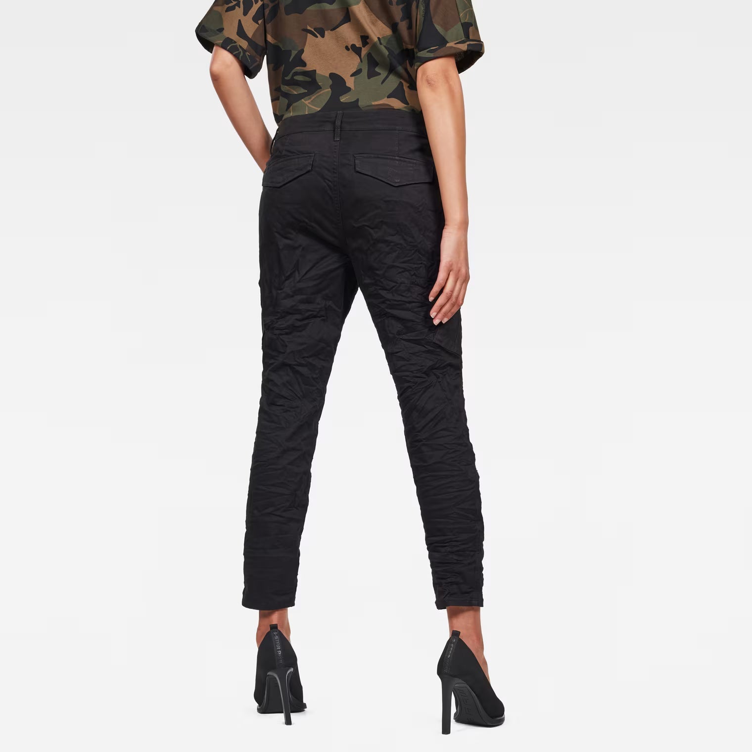 Back view of the black skinny cargo pants showcasing mid waist and cargo pockets.
