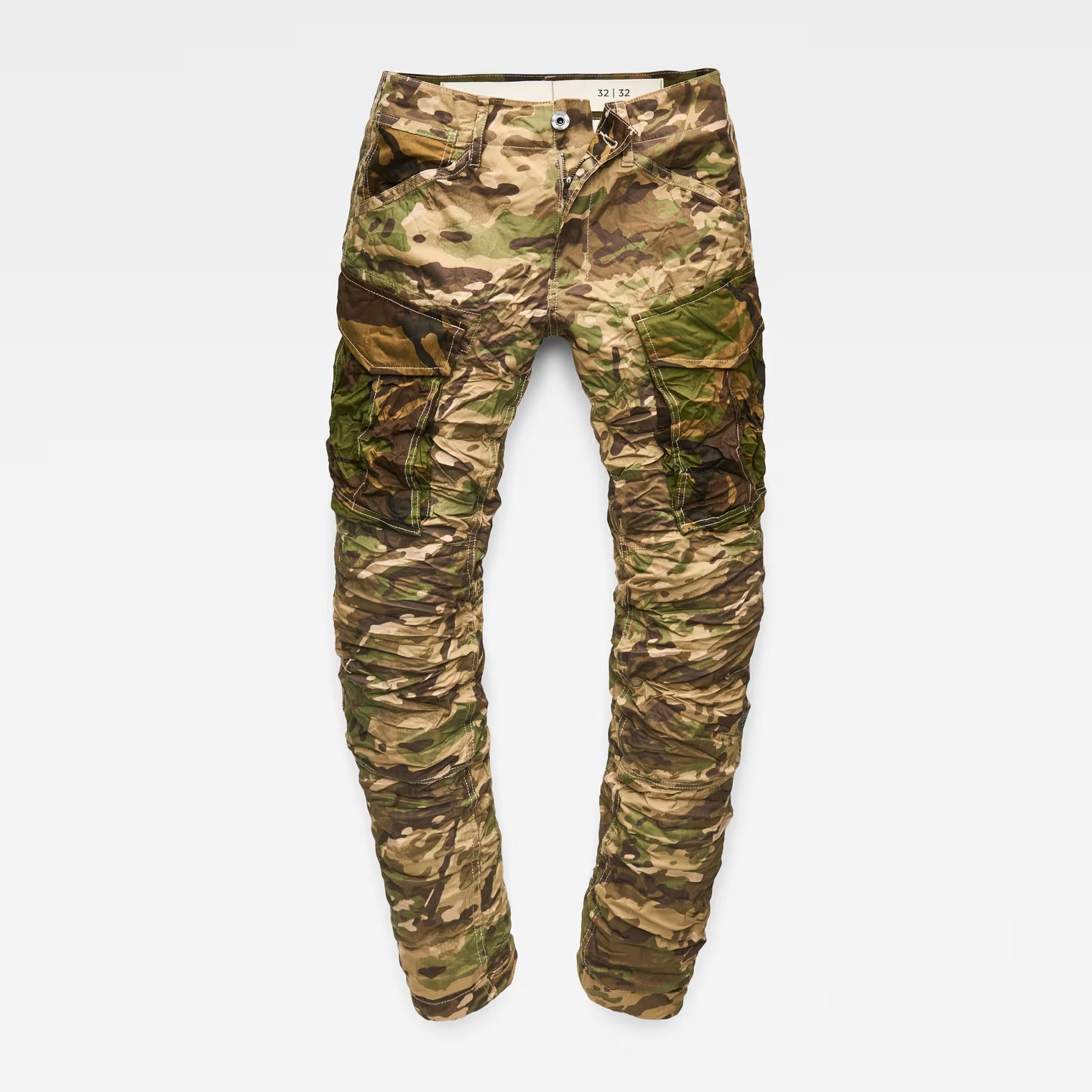 Flat lay of beige tapered pants with camouflage pattern on a white background