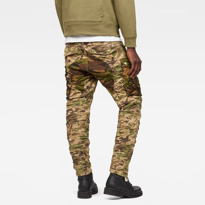 Back view of beige tapered pants featuring pocket details on a white background