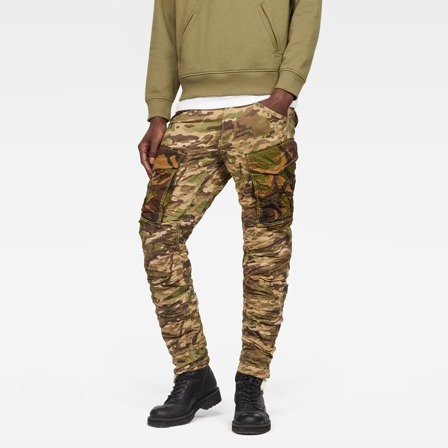 Front view of beige tapered pants with camouflage pattern on a white background