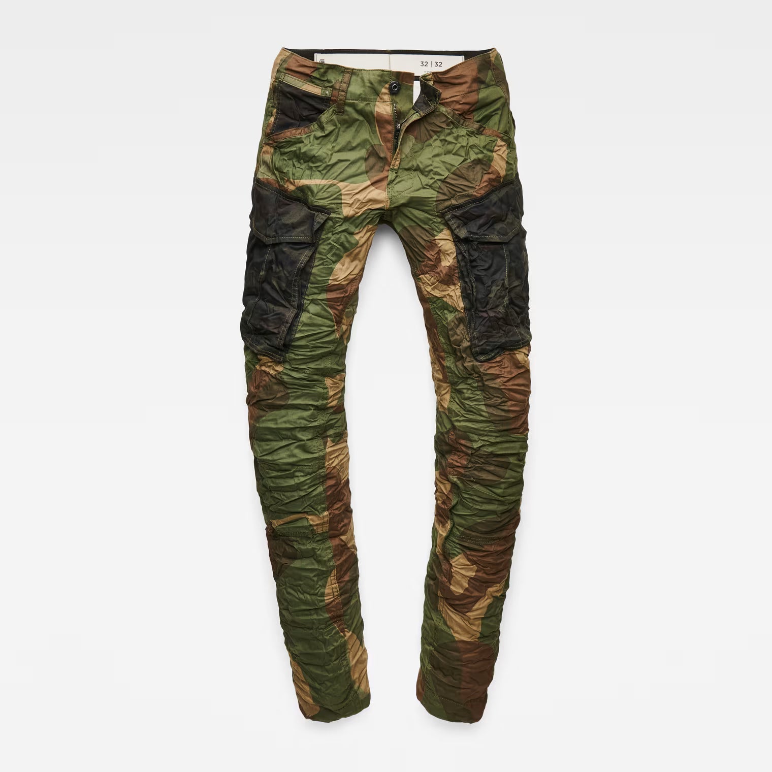 Detail view of the flat front of the green tapered pants with cargo pockets.