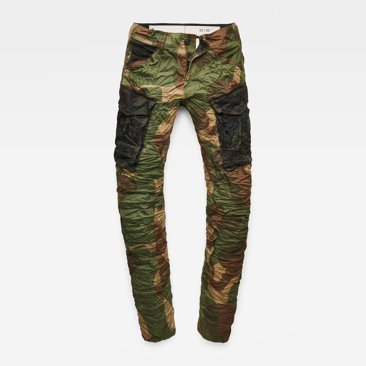 Detail view of the flat front of the green tapered pants with cargo pockets.