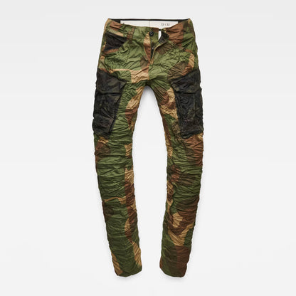 Detail view of the flat front of the green tapered pants with cargo pockets.