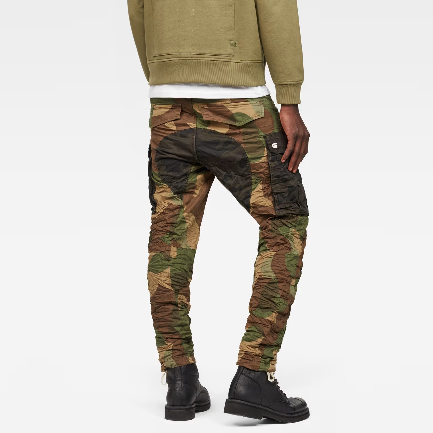 Back view of the green tapered pants showcasing the camouflage design and cargo pockets.