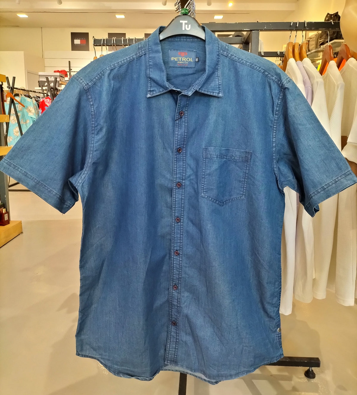 Petrol blue short-sleeve denim shirt on hanger, front view