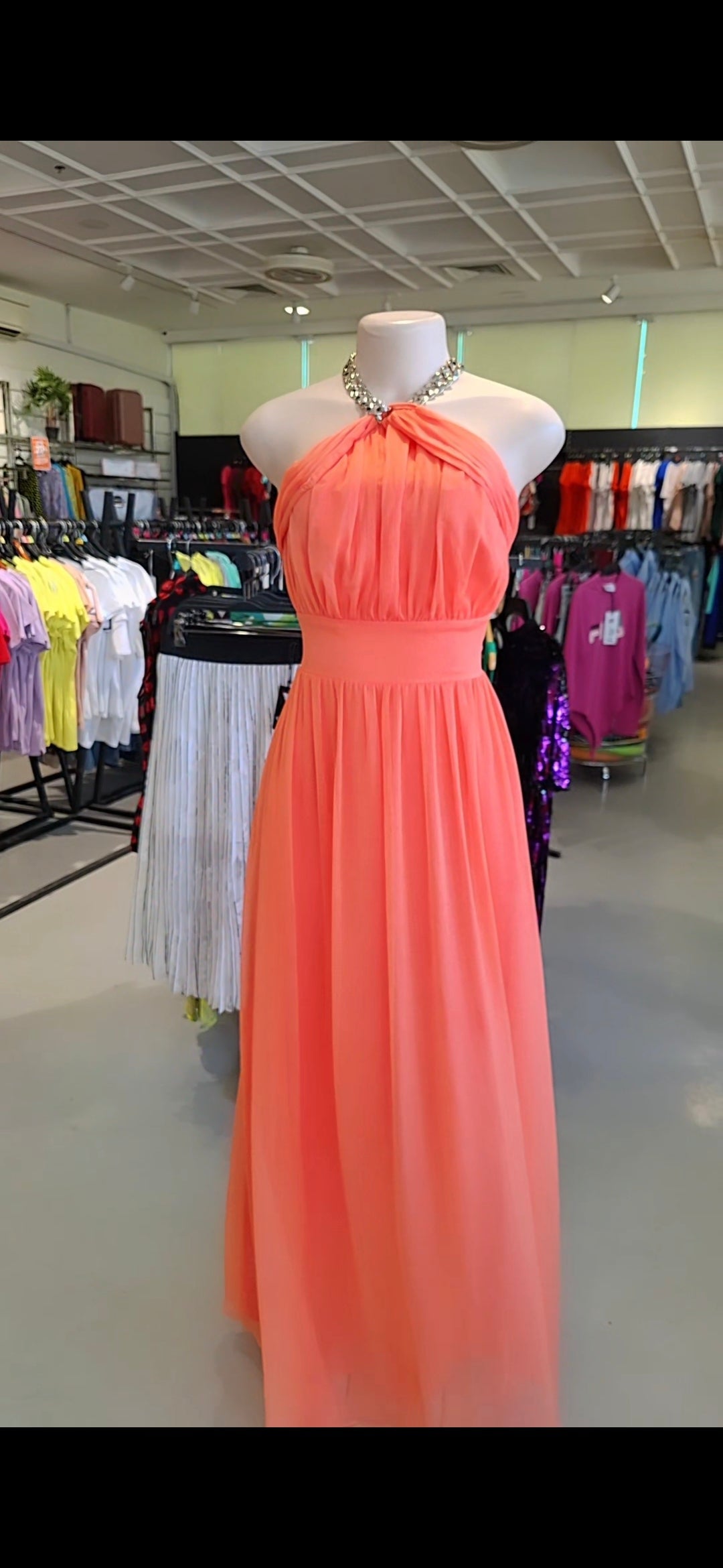 Americano Guess coral halter maxi dress displayed on mannequin in store