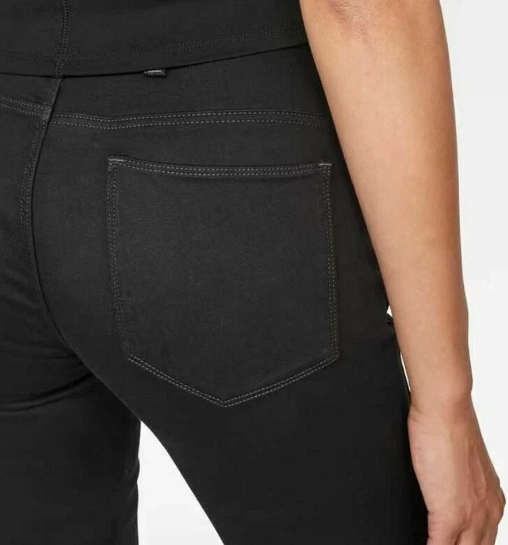 Back view of the black jeans showcasing back pockets and stitching details on a white background.