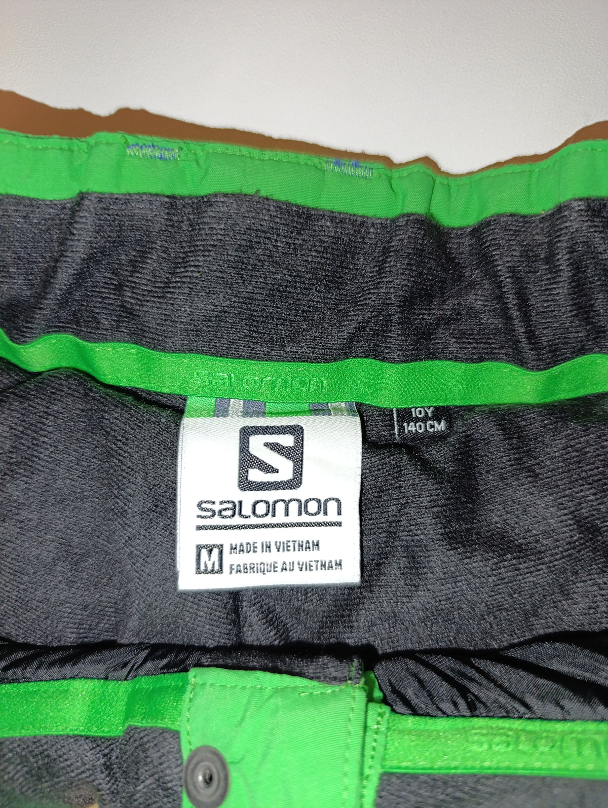 Close-up of Salomon ski pants waistband and size label