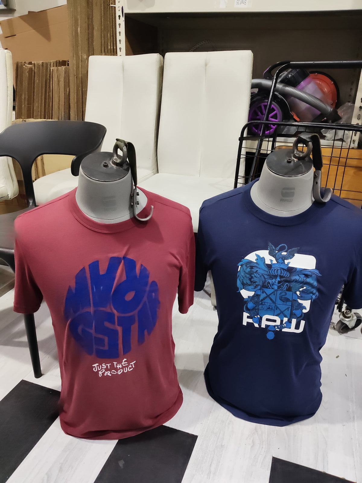 Two male torso mannequins in red and navy t-shirts, front view