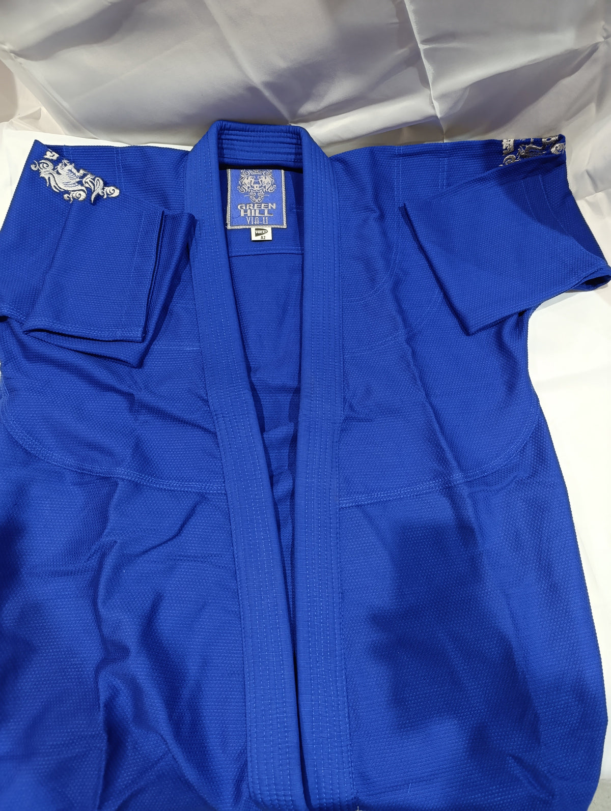 Blue Green Hill judo gi jacket laid flat