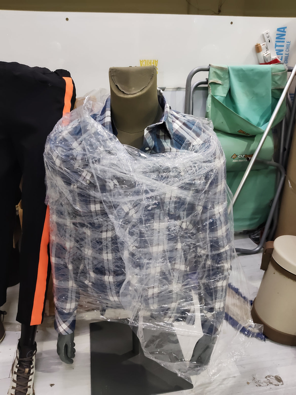 Male half-body torso mannequins wrapped in plastic