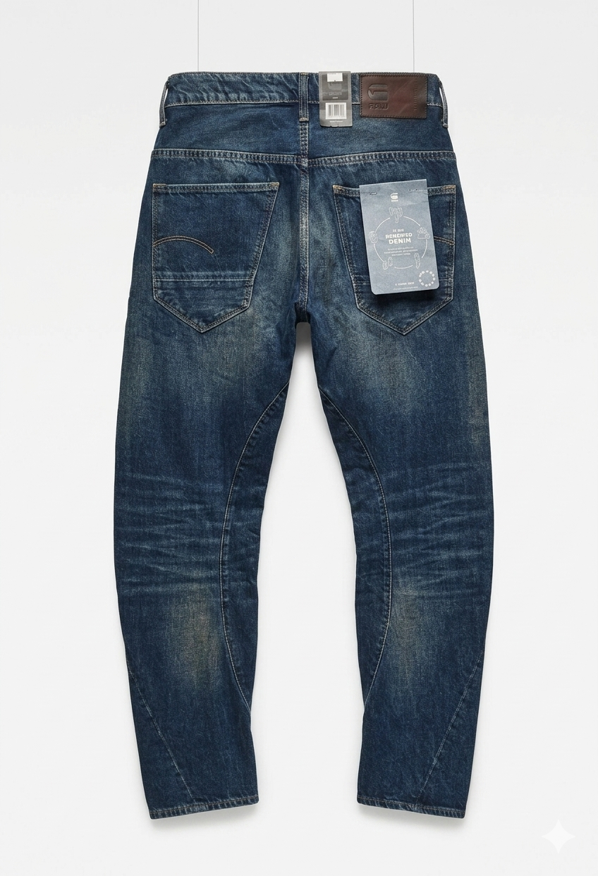 Back view of blue G-Star RAW Arc 3D Tapered Jeans showing tag and two back pockets on a white background