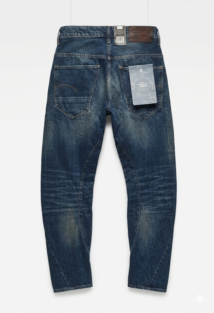 Back view of blue G-Star RAW Arc 3D Tapered Jeans showing tag and two back pockets on a white background