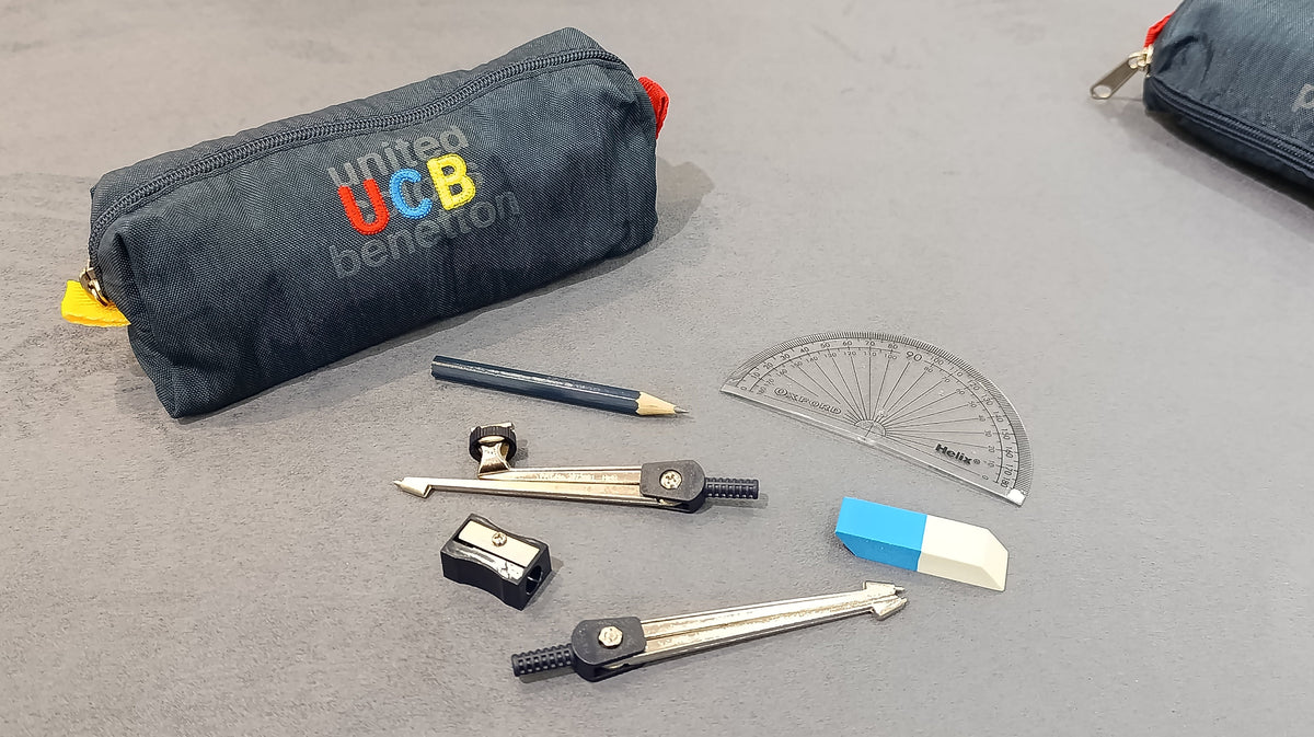 Benetton navy pencil case shown with scissors, sharpener and other stationery