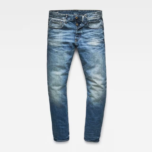Front view of blue distressed jeans featuring a slim fit on a white background.