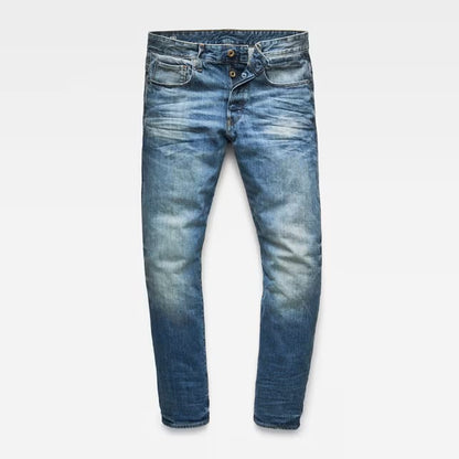 Front view of blue distressed jeans featuring a slim fit on a white background.