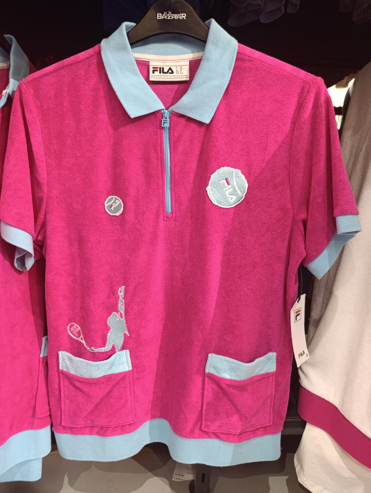 Fila pink terry polo shirt with light blue trim and zip collar on hanger