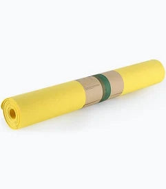 Yellow UMINEUX yoga mat rolled with paper band