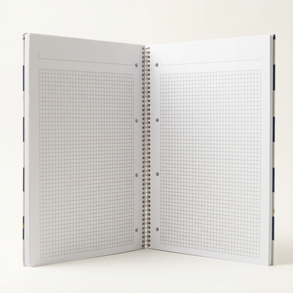 Spiral notebook open to show grid-ruled pages