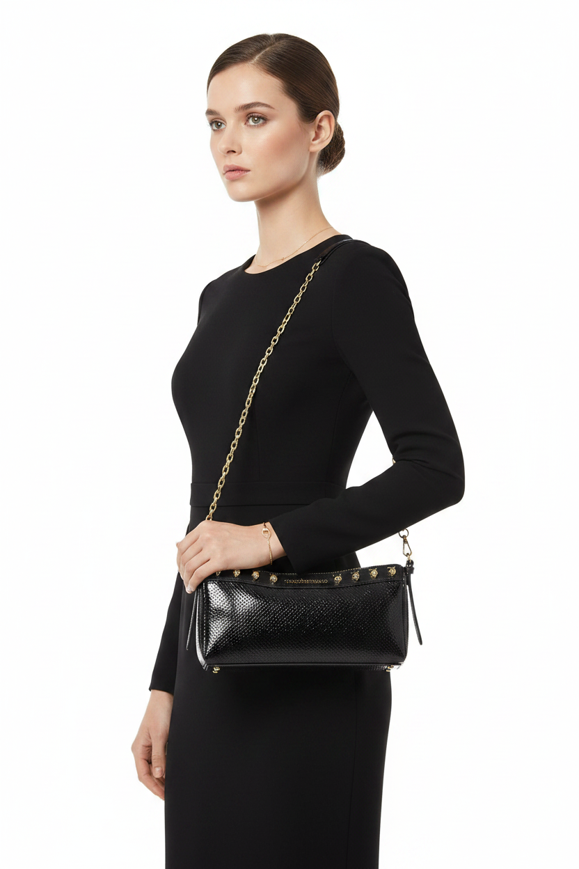 Woman wearing black studded chain bag