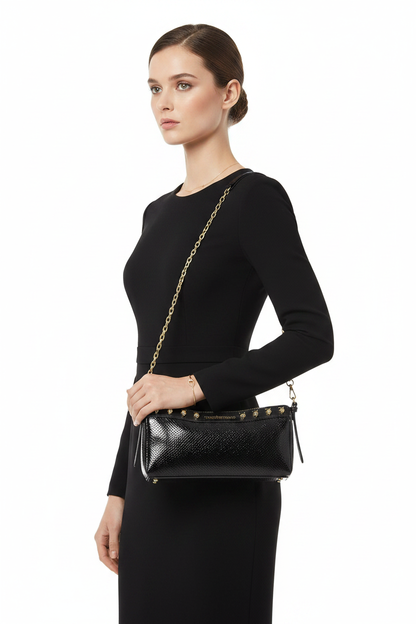 Woman wearing black studded chain bag